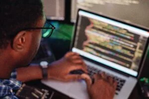 black male in front of computer screen coding mobi 2022 11 15 06 43 22 utc